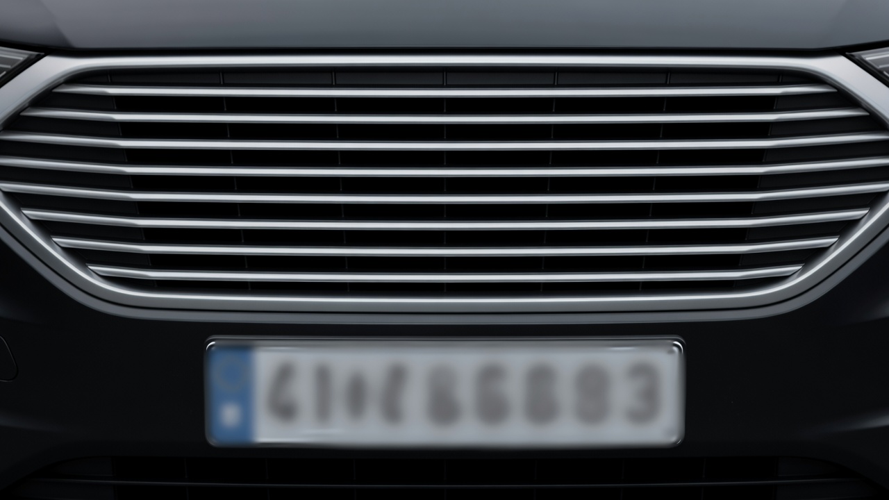 Close up of a generic vehicle grille and blurred plate area